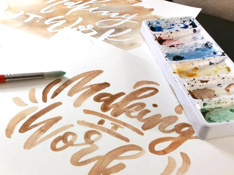 Watercolor paper and paints showing art with text "Making It Work"